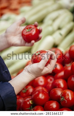 Close Up Woman\'s Hands Holding Tomato At Market Place