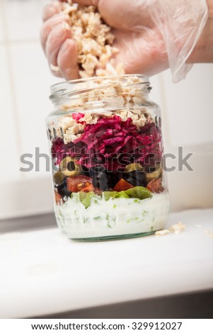 Making Jar Salads. Close Up Of Human Hand Putting Ingredients In Jar