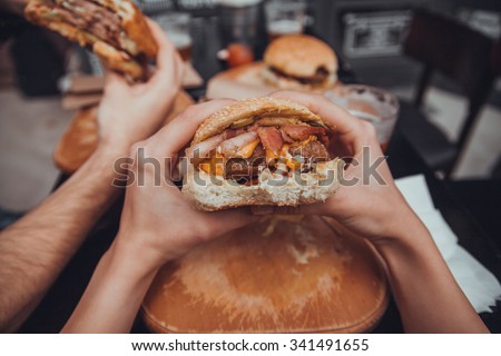 Close Up Of Female Hands Holding Delicious Bacon Burger