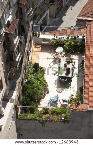 Terrace on the roof with green garden and flowers