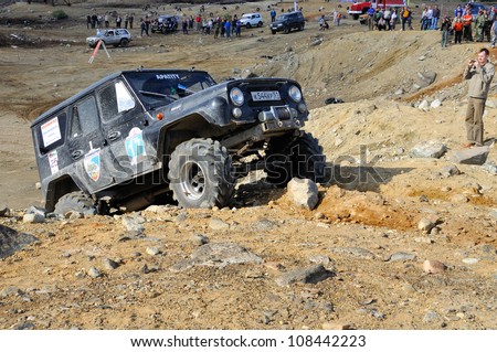 MONCHEGORSK, RUSSIA - JULY 15: Unidentified racer at off-road car leaves steep slope in the \