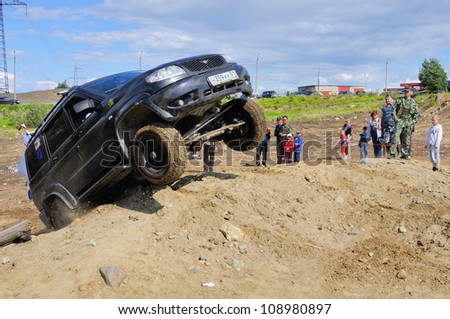 MONCHEGORSK, RUSSIA - JULY 15: Unidentified racer at off-road car leaves steep slope in the 