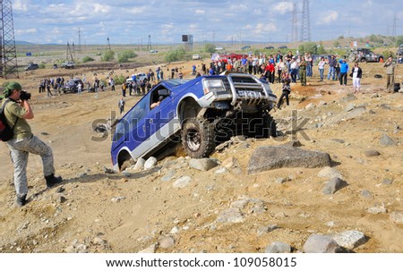 MONCHEGORSK, RUSSIA - JULY 15: Unidentified racer at off-road car steep slope in the \