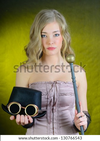 Steampunk female with a cane, top hat and goggles.