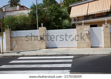 photo gates, flower beds, fences, gables of houses in a small town near Barcelona, Spain.
