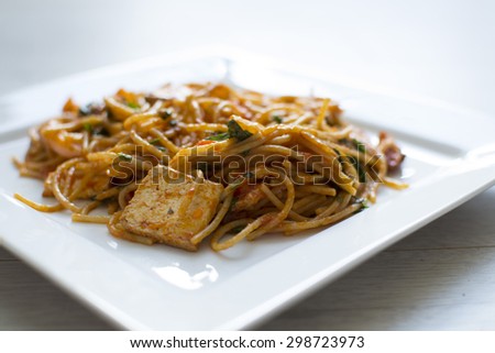 Vegan spaghetti with tofu and pepper delicious on white plate