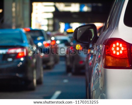 Close up of tail light of a car waiting in long queue of traffic. Stopped car with its brake lights on in the city of Melbourne, Australia.