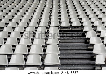 Tribune sports stadium, gray chairs arranged in rows