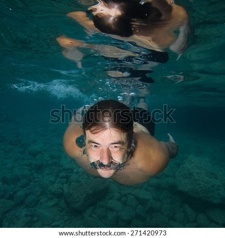 Swimmer underwater with open eyes