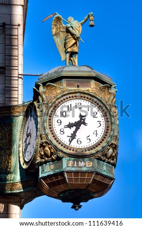 The 1926 decorative jewelers\' building clock in Chicago is emblazoned with the word TIME and decorated with a statue of old Father Time.