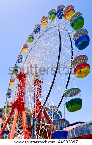 A colorful ferris wheel against a blue sky