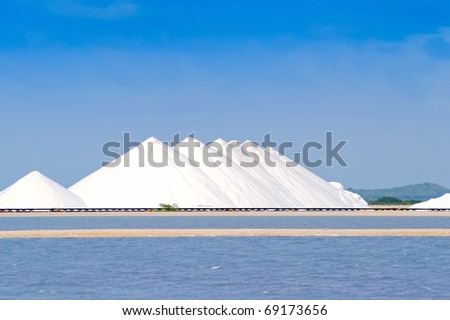 Storage hills of sea salt against salt pans of Bonaire