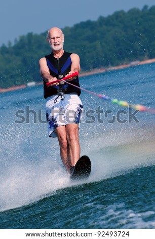 An active senior demonstrates his fitness and prowess on his water-ski.