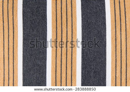 Striped black and yellow fabric background texture close up