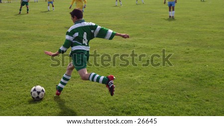 young boy playing football,soccer