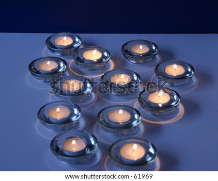 12, twelve tea light candles on blue background