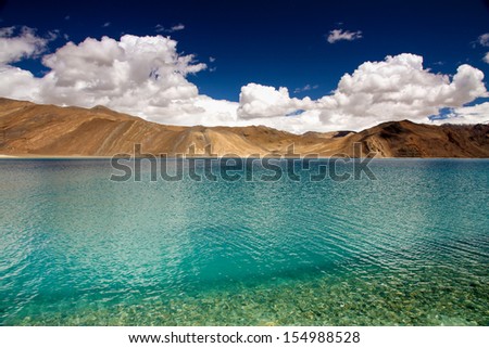 Blue and Turquoise Lake with Mountains in the Back and Deep Blue Sky - Pangong Lake, Ladakh, India