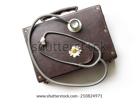 Concept of healthcare with old First aid bag and accessories, stethoscope and old suitcase on white background