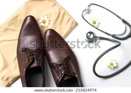 Concept of healthcare with old First aid bag and accessories, stethoscope and slingbacks  on white background