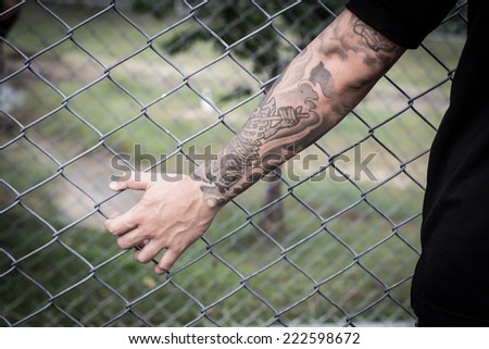 hand in jail, tattoo on hand,hand clutching prison,no escape