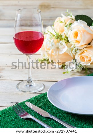 Glasses set with dinner table,dinner table with rose ,dish ,knife and fork set