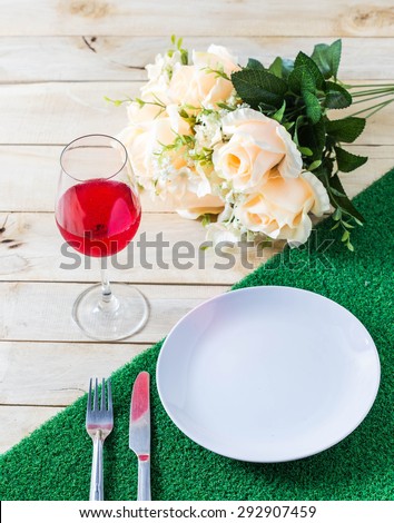 Glasses set with dinner table,dinner table with rose ,dish ,knife and fork set