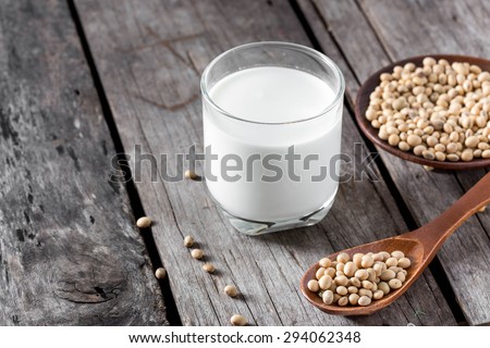 Soy milk and soy bean on wood background