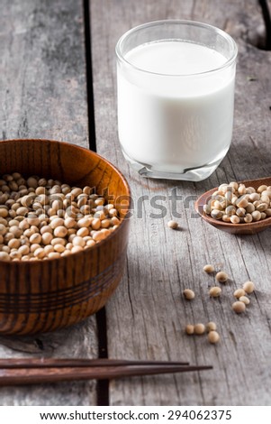 Soy milk and soy bean on wood background
