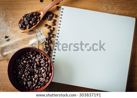 note book for recipes and menus decorated with coffee beans on wood background