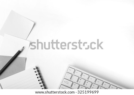 Office table with note book,paper ,pencil and computer,top view,black and white style