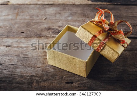 Gift box open on wooden table