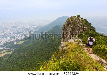HONG KONG, CHINA - 29 SEPTEMBER 2013 - Peak of Lion Rock with a climber, on 29 Sept 2013, in Kowloon, Hong Kong.