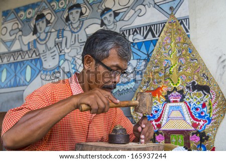 CIRCA JUNE 2012 - JAVA, INDONESIA - A craftsman makes a shadow puppet, on 20 June 2012, in Yogyakarta, Java, Indonesia.
