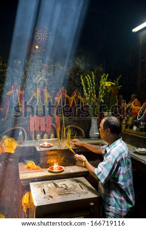 19 AUGUST 2011 - HO CHI MINH CITY, VIETNAM - Worshipper prays at the altar in the Jade Emperor Pagoda, on 19 August 2011, in Ho Chi Minh City, Vietnam
