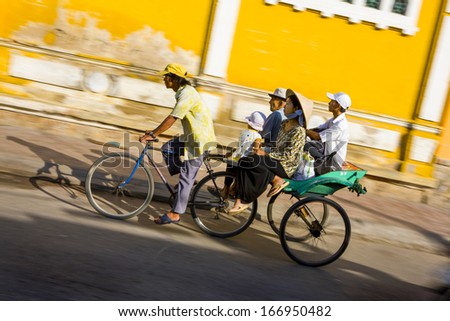 CIRCA OCTOBER 2011 - CHAU DOC, VIETNAM - A family rides on a bike trailer, on 4 October 2011, in Can Tho, Mekong Delta, Vietnam