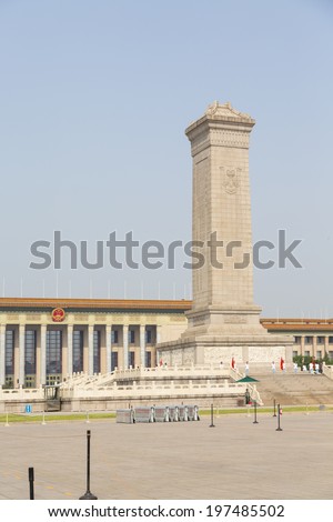 BEIJING, CHINA - MAY 18, 2014 - BEIJING, CHINA - Monument to the People's Heroes in the centre of Tiananmen Square, with the Great Hall of the People in the background, Beijing