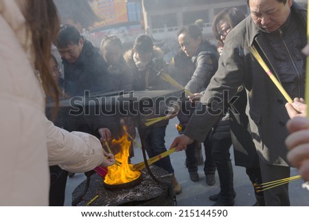 15 JANUARY 2014 - SHANGHAI, CHINA - Worshippers light incense sticks at Jing An Temple, Shanghai