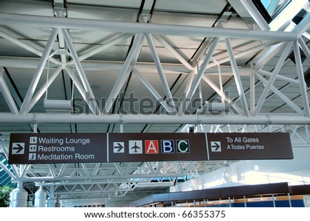 Airport passenger terminal direction signs to restroom, lounge, and meditation room