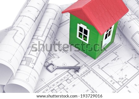 Model house with design drawings / Image model home on design drawings in the background of wooden boards