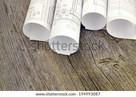 Project drawings on the background of wooden boards/ Image of several drawings for the project engineer jobs