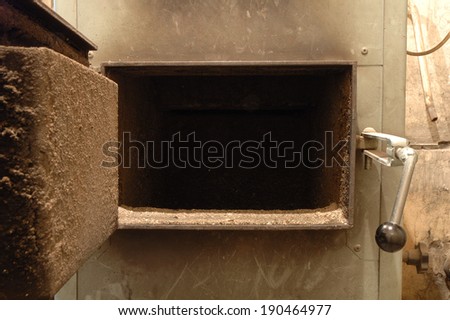 Old oven's open door in old boiler room