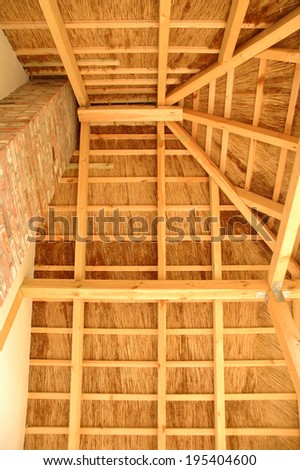 Roof covered with straw and it\'s wooden construction