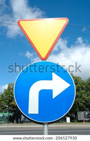 two road signs give way and turn right