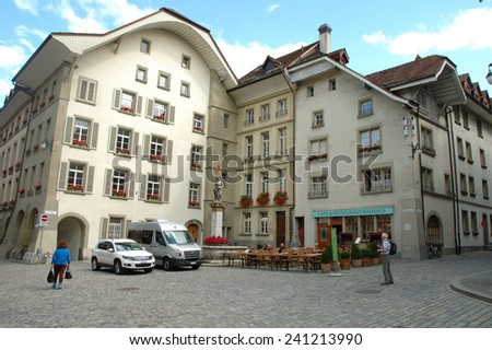 Bern, Switzerland - August 15, 2014: Unidentified people on cobbled street in Bern, Switzerland.