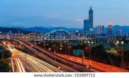 night view of Taipei city with skyscraper and traffic trails