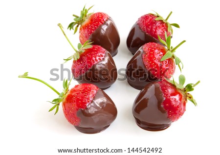 Row of strawberries dipped in delicious chocolate isolated on the white background