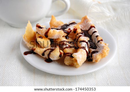 Sweet crunchy stick with chocolate coating on the white plate