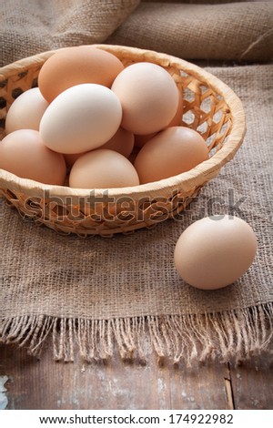Organic eggs in the basket on the cloth