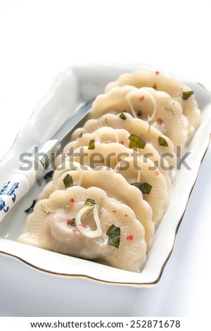 Traditional boiled dumplings with filling on the white background