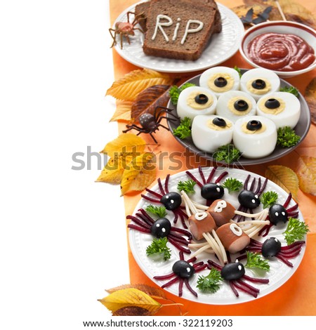 Food for the Halloween day, boiled egg as the creepy eyes, spiders with olives and beets, bread, sausages with spaghetti